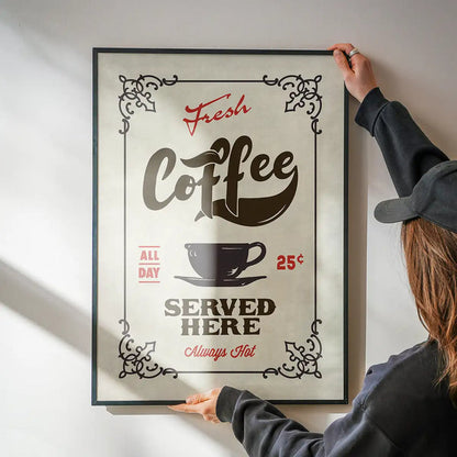 Fresh Coffee Served Here Colour Print being hung on a wall in a black frame