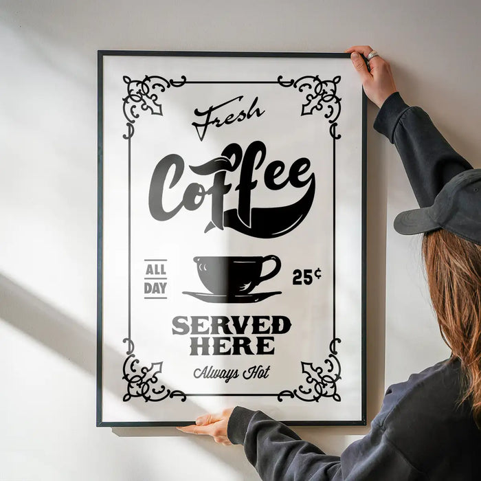 Fresh Coffee Served Here Print being hung on a wall in a black frame
