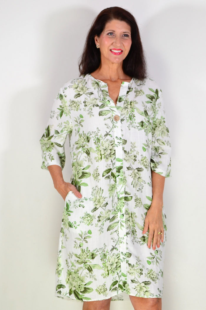 Green floral linen blend tunic by La Mode, lightweight and flowy with a botanical print, displayed on a hanger.