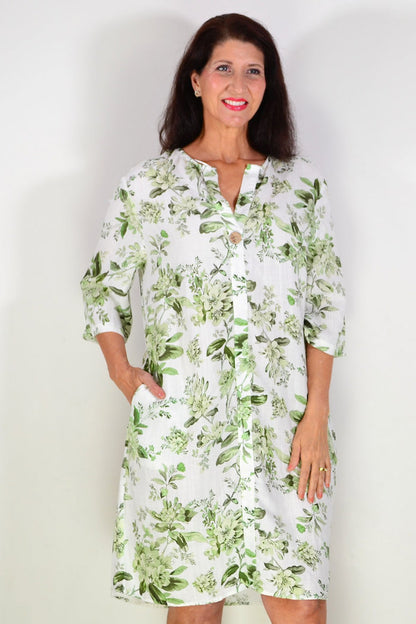 Green floral linen blend tunic by La Mode, lightweight and flowy with a botanical print, displayed on a hanger.