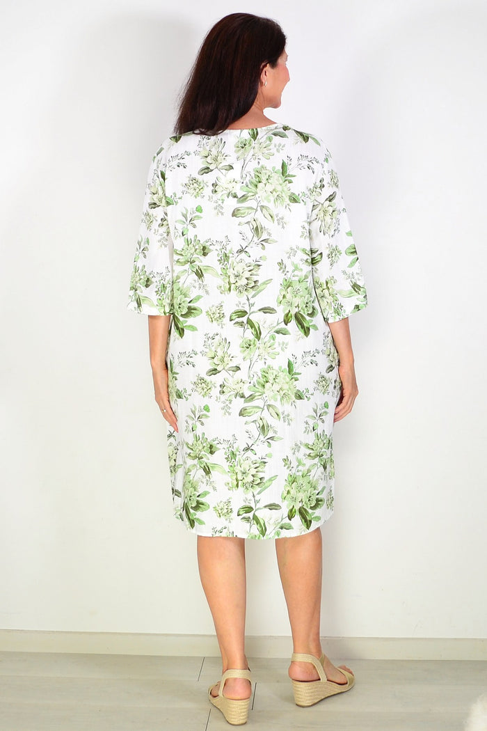 Green floral linen blend tunic by La Mode, featuring a relaxed fit and v-neck, displayed on a hanger against a neutral background.