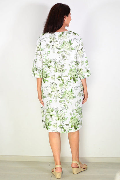 Green floral linen blend tunic by La Mode, featuring a relaxed fit and v-neck, displayed on a hanger against a neutral background.