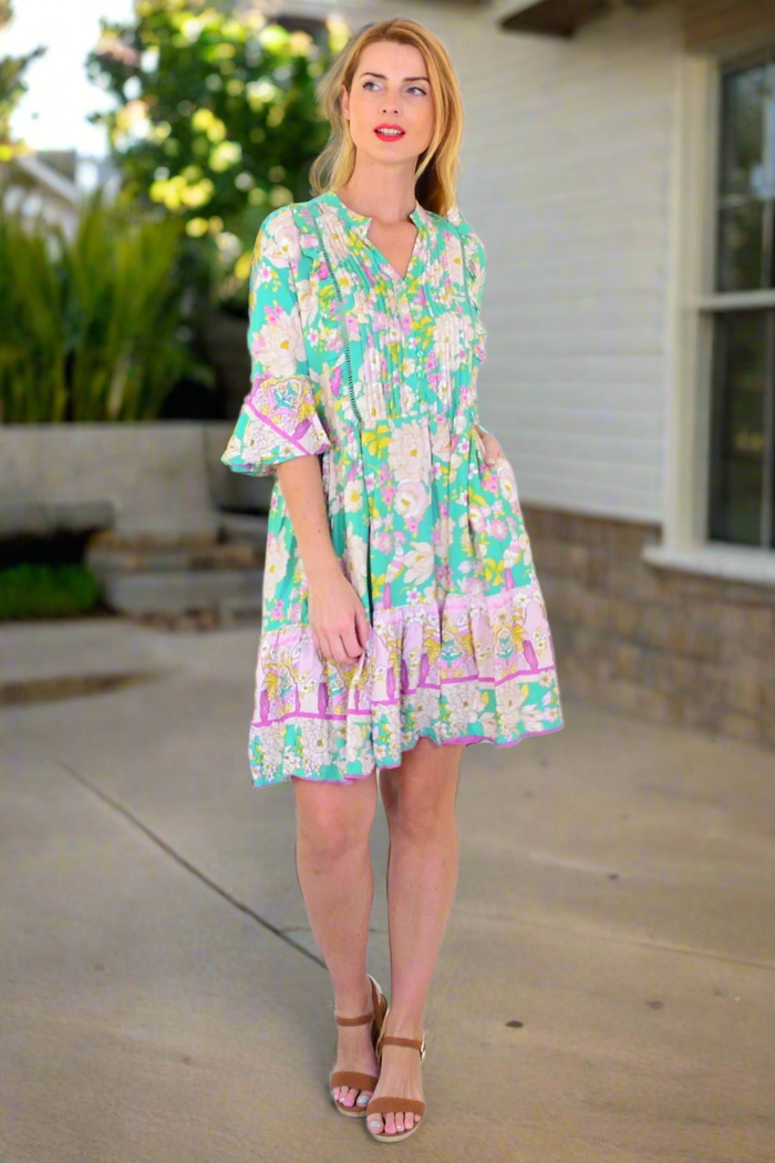 Green floral print bohemian tunic dress by Dream featuring a flowing silhouette and vibrant botanical patterns.