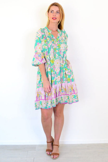 Green floral print bohemian tunic dress by Dream, featuring a flowy design and vibrant garden-inspired pattern.