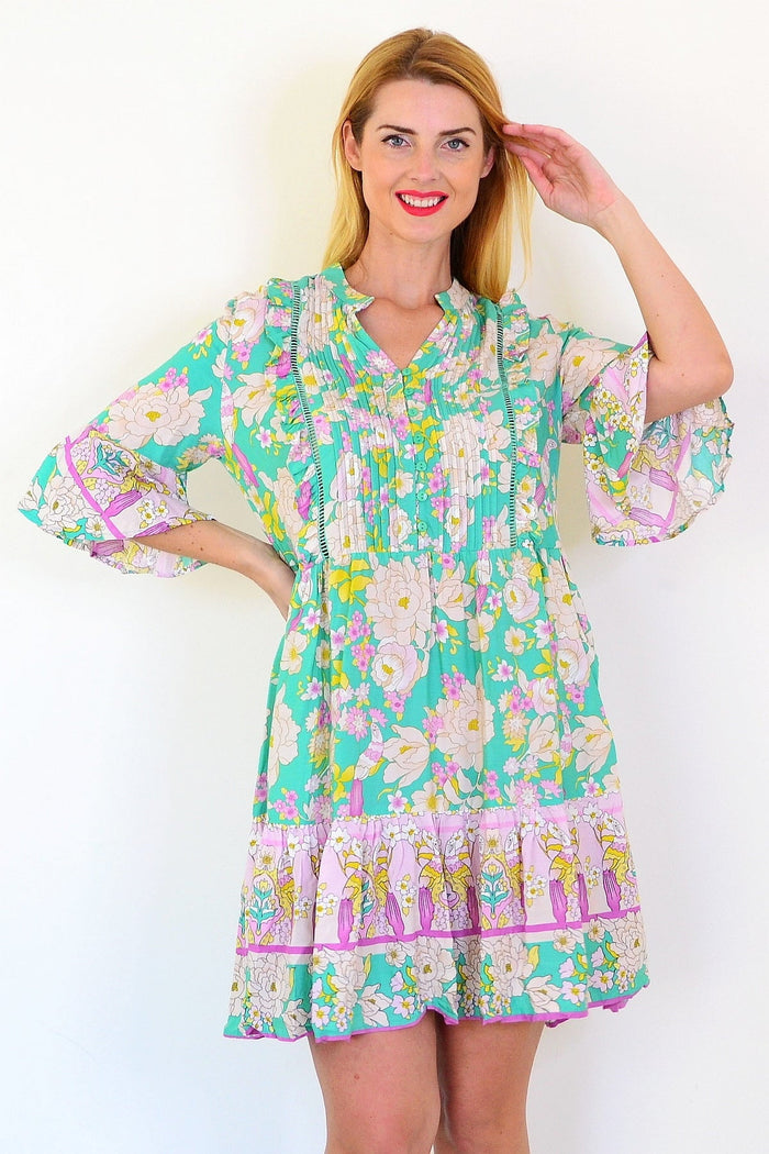 Green floral print bohemian tunic dress by Dream, featuring a flowy fabric and vibrant boho floral design.