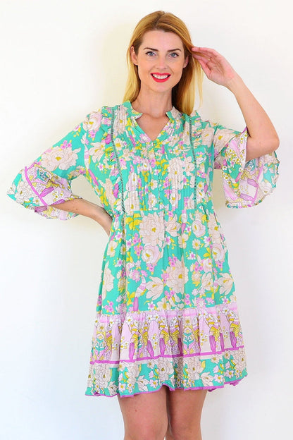 Green floral print bohemian tunic dress by Dream, featuring a flowy fabric and vibrant boho floral design.