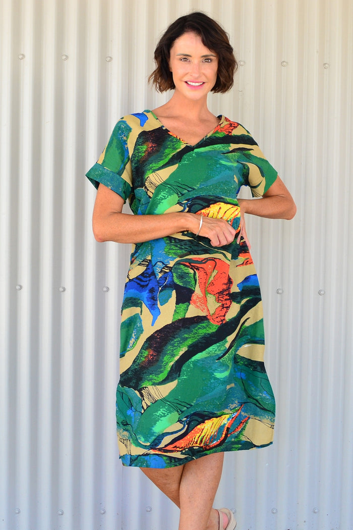 Green and orange playful tunic dress by Hourglass, featuring vibrant color blocks and a relaxed fit, displayed on a mannequin.