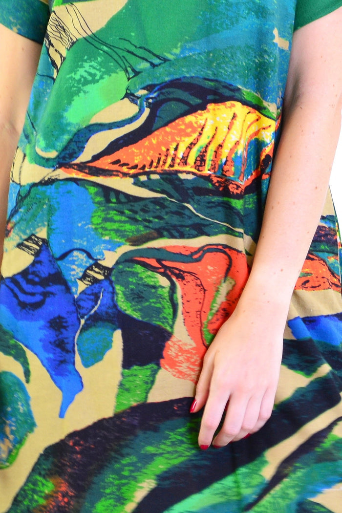 Green and orange playful tunic dress by Hourglass with a relaxed fit, displayed on a hanger against a plain background.