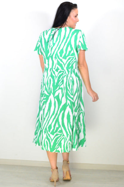 Hourglass green and white striped tunic dress displayed on a hanger, showcasing its casual, stylish design and lightweight fabric.