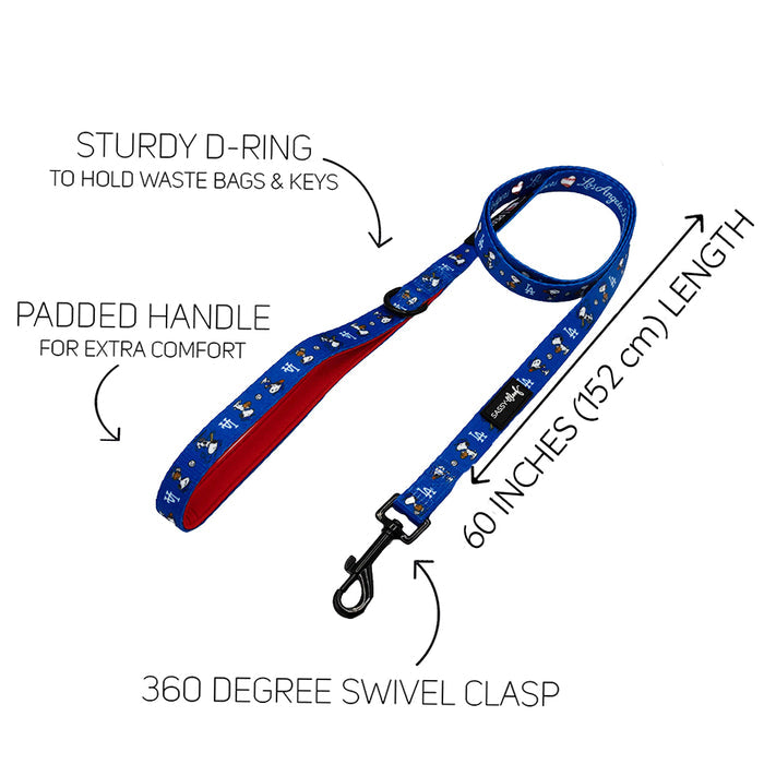 The Sassy Woof Dog Leash - MLB™ x Peanuts™ Los Angeles Dodgers™ features a blue design with Snoopy, white and yellow dog bones, padded red handle, sturdy D-ring for bags/keys, 360° swivel clasp, and is 60 inches (152 cm) long.