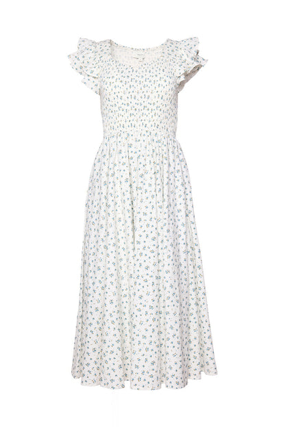 The Hattie Dress in Madeline Blue by Ivy City Co is a white, ankle-length cotton midi dress with a smocked bodice, short ruffled sleeves, and a delicate blue and green floral print. Its flowy skirt highlights the feminine, summery style.