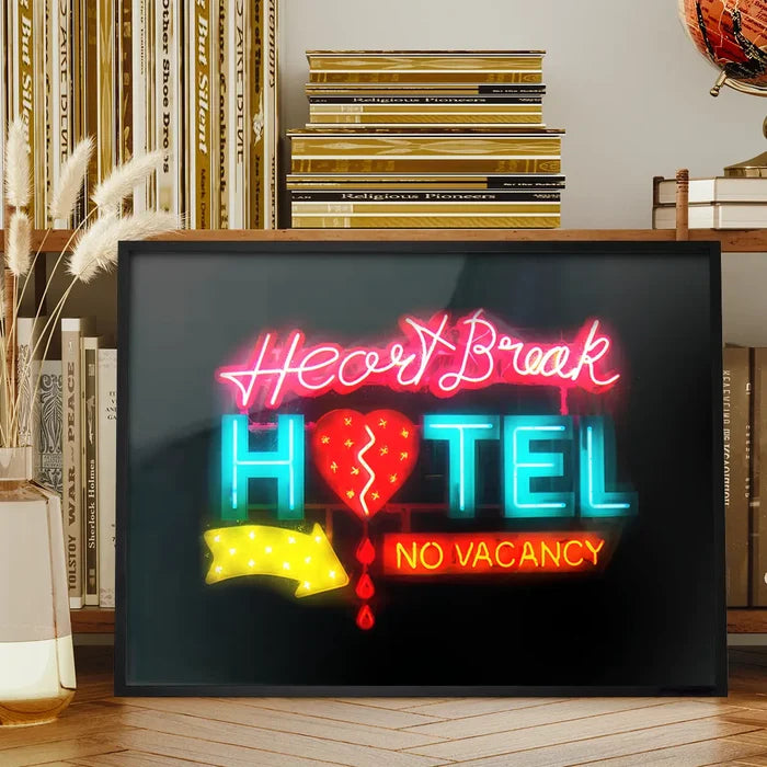 Framed neon-style art print featuring a glowing Heartbreak Hotel sign with a broken heart icon on black archival paper.