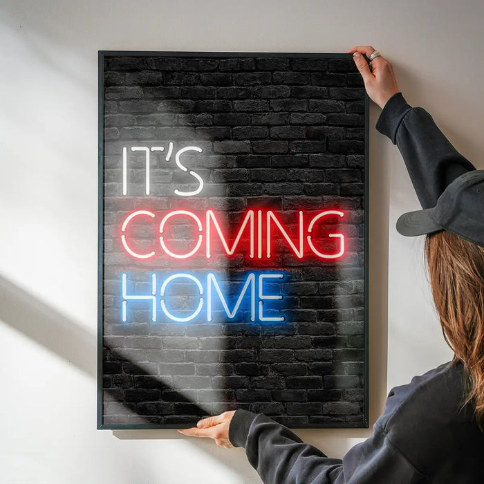 It's Coming Home England Football Poster Print being hung on a wall in a black frame