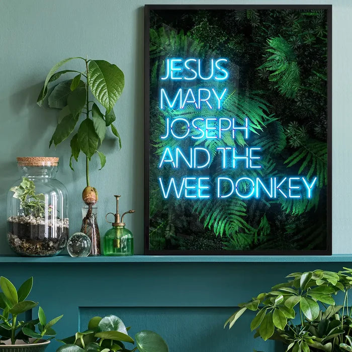 Jesus Mary Joseph Wee Donkey TV Quote Print, typography print black framed on a living room shelf