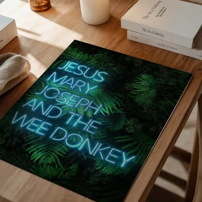 Jesus Mary Joseph Wee Donkey TV Quote Print, typography print unframed on a home office desk