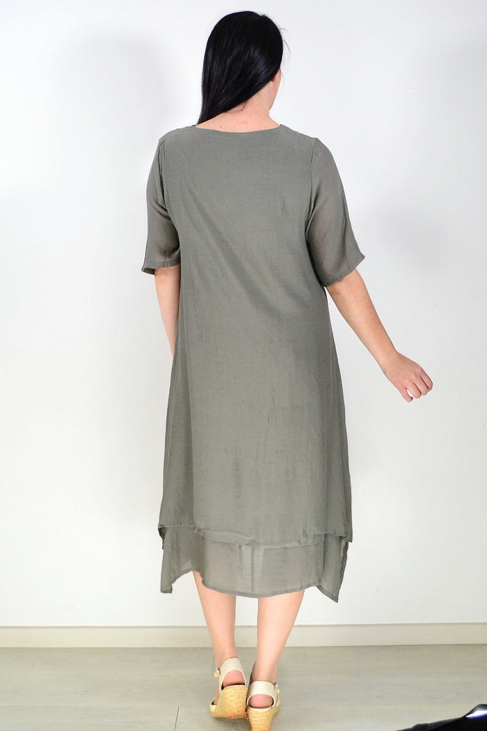 Khaki green summer tunic dress by La Mode, lightweight fabric with a relaxed fit and casual style, shown on a hanger.