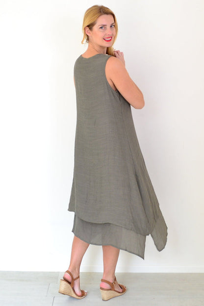Khaki sleeveless tunic dress with coconut button details by La Mode, displayed on a hanger showcasing its relaxed fit and fabric.