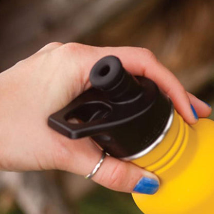 Woman holding a Klean Kanteen stainless stell water bottle with a black sports cap