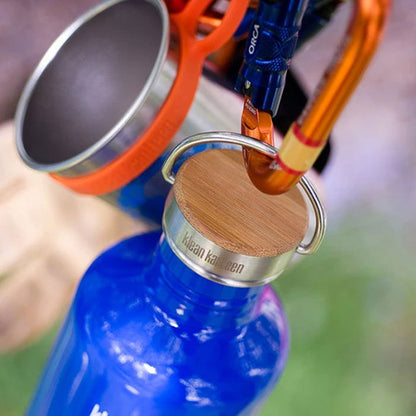 Klean Kanteen stainless steel leakproof water bottle cap with bamboo clipped to a carabiner using the looped carry handle