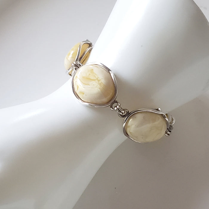 modern large butterscotch link amber bracelet on hand