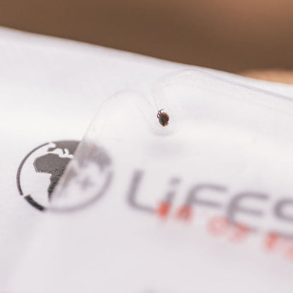 A tick shown in the tool slot after being removed using a Lifesystems compact tick removal card