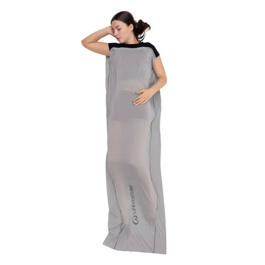 Woman asleep inside a Lifeventure Cotton Sleeping Bag Liner Rectangular on a white background