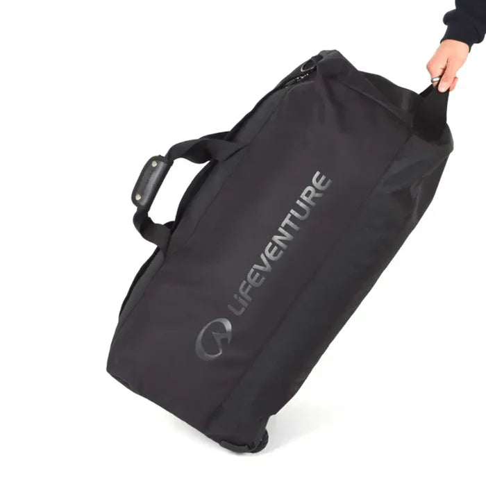 Lifeventure Expedition Wheeled Duffle Bag 120 Litres in black being pulled by the handle on a white background