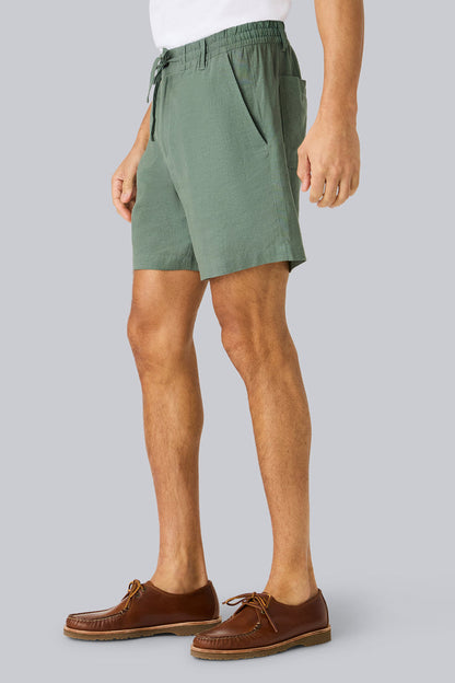 Side view of a man wearing Linen Drawstring Short in Cactus
