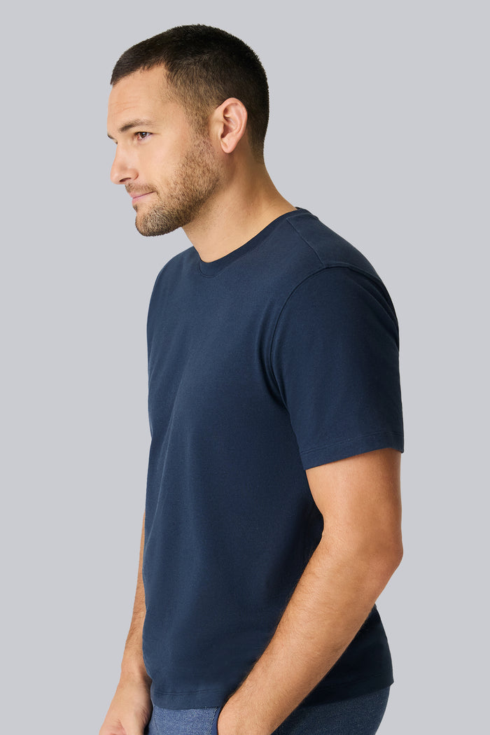 Side view of a man wearing Linen Jersey Crew Neck T-shirt in Total Eclipse