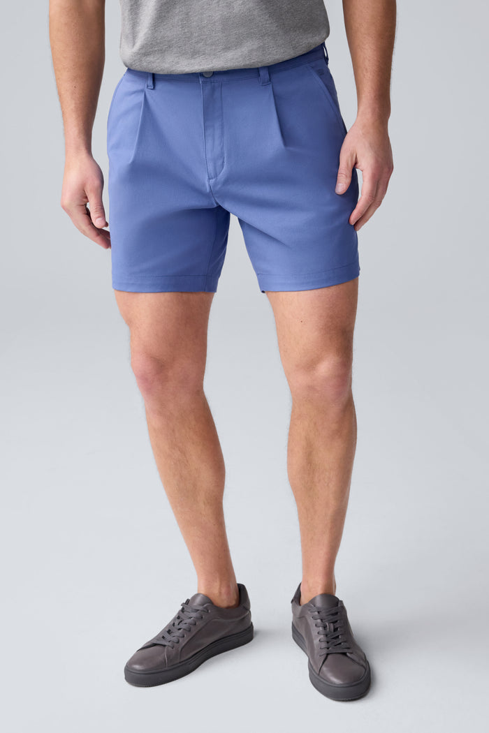 Front view of a man wearing Maverick Tech Chino Pleated Short in Wild Rapids