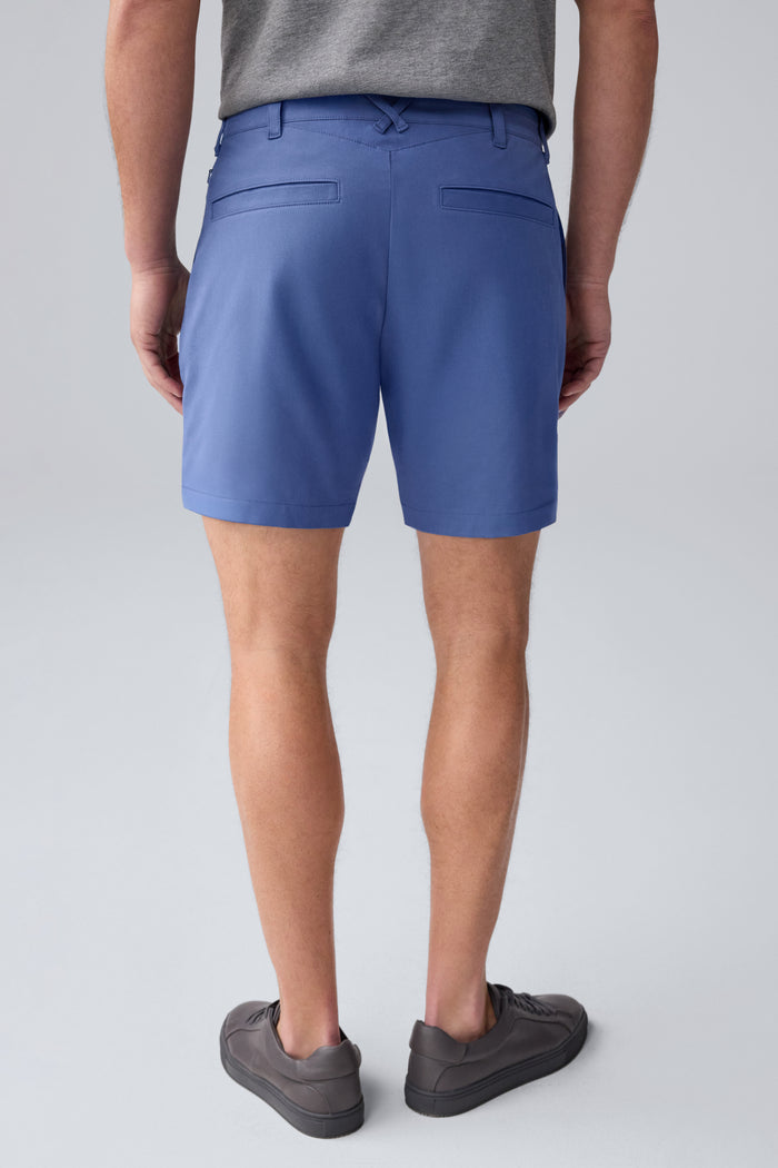 Back view of a man wearing Maverick Tech Chino Pleated Short in Wild Rapids
