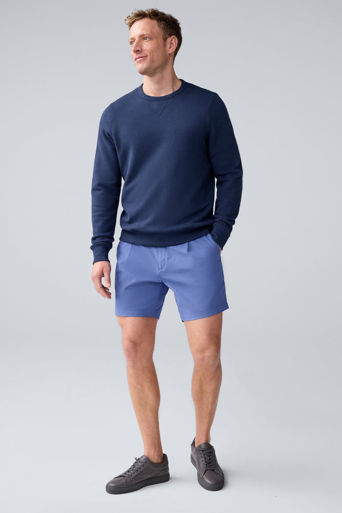 Full front view of a man wearing Maverick Tech Chino Pleated Short in Wild Rapids