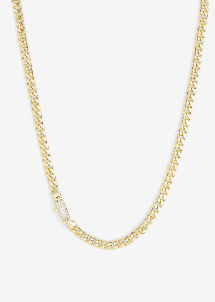 Gold chain necklace with a lock clasp and pave accents on a white background