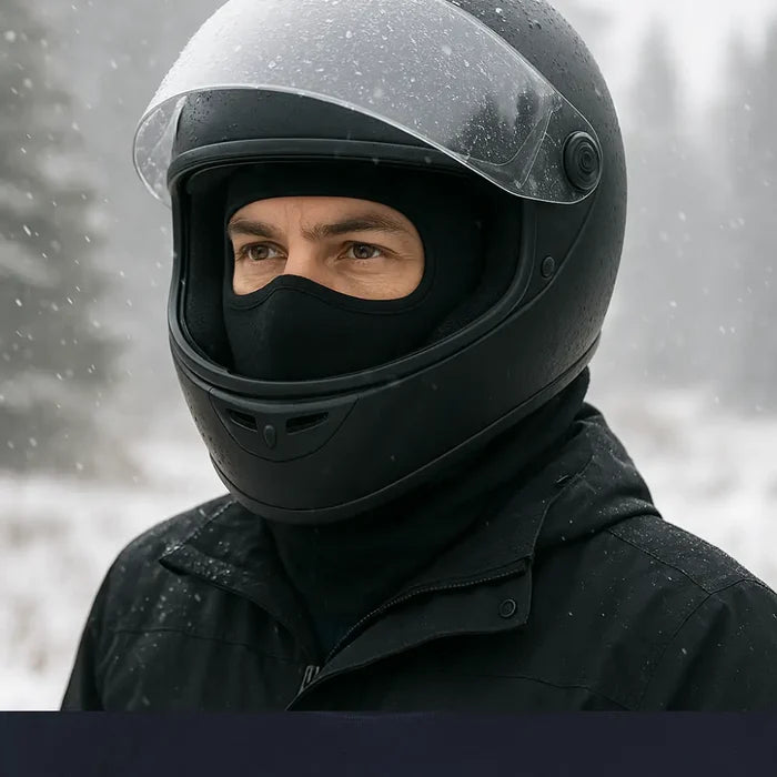 Person wearing a Sub Zero Meraklon thermal balalclava under their motorbike helmet outdoors in the snow