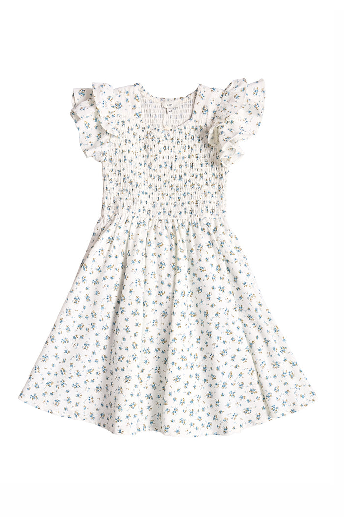 The Mini Hattie Dress in Madeline Blue by Ivy City Co is a charming girls’ cotton midi dress featuring a smocked bodice, ruffled short sleeves, flared skirt, and blue floral pattern on white—perfect for any occasion.