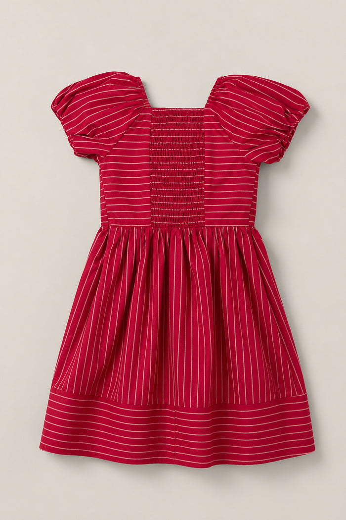The Mini Julie Dress in Cranberry Pinstripe by Ivy City Co features charming puff sleeves, a beautifully smocked bodice, a square neckline, and a full gathered skirt finished with a horizontal pinstripe hem border.