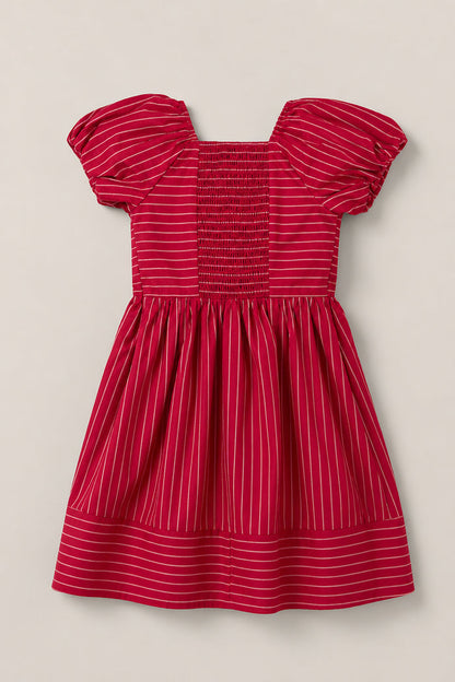 The Mini Julie Dress in Cranberry Pinstripe by Ivy City Co features charming puff sleeves, a beautifully smocked bodice, a square neckline, and a full gathered skirt finished with a horizontal pinstripe hem border.