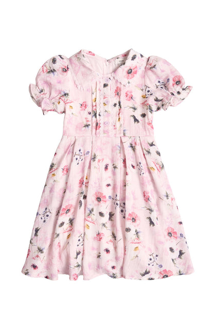 The Mini Sophia Dress in Roselyn Pink by Ivy City Co features puffed sleeves, a pleated bodice, and a floral print—ideal for matching mommy and me looks.