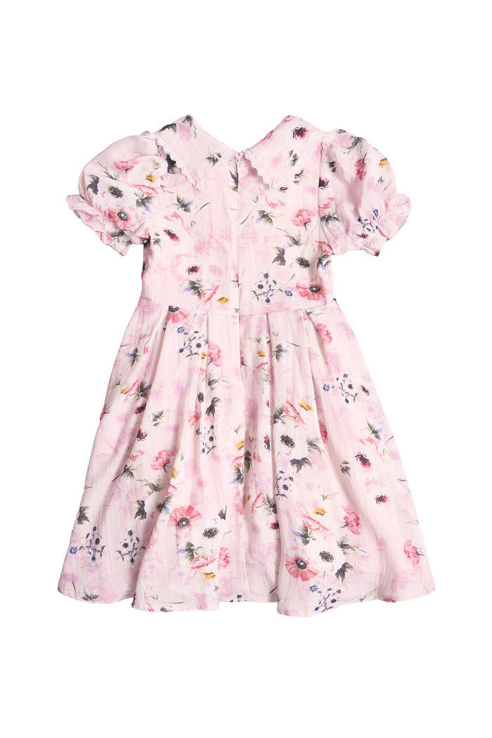 The Mini Sophia Dress in Roselyn Pink by Ivy City Co is a girls’ knee-length, short-sleeved dress with a floral print, puffed sleeves, gathered waist, and back zipper—ideal for matching mommy and me looks. Shown on a white background.
