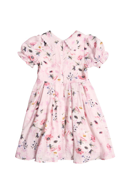 The Mini Sophia Dress in Roselyn Pink by Ivy City Co is a girls’ knee-length, short-sleeved dress with a floral print, puffed sleeves, gathered waist, and back zipper—ideal for matching mommy and me looks. Shown on a white background.