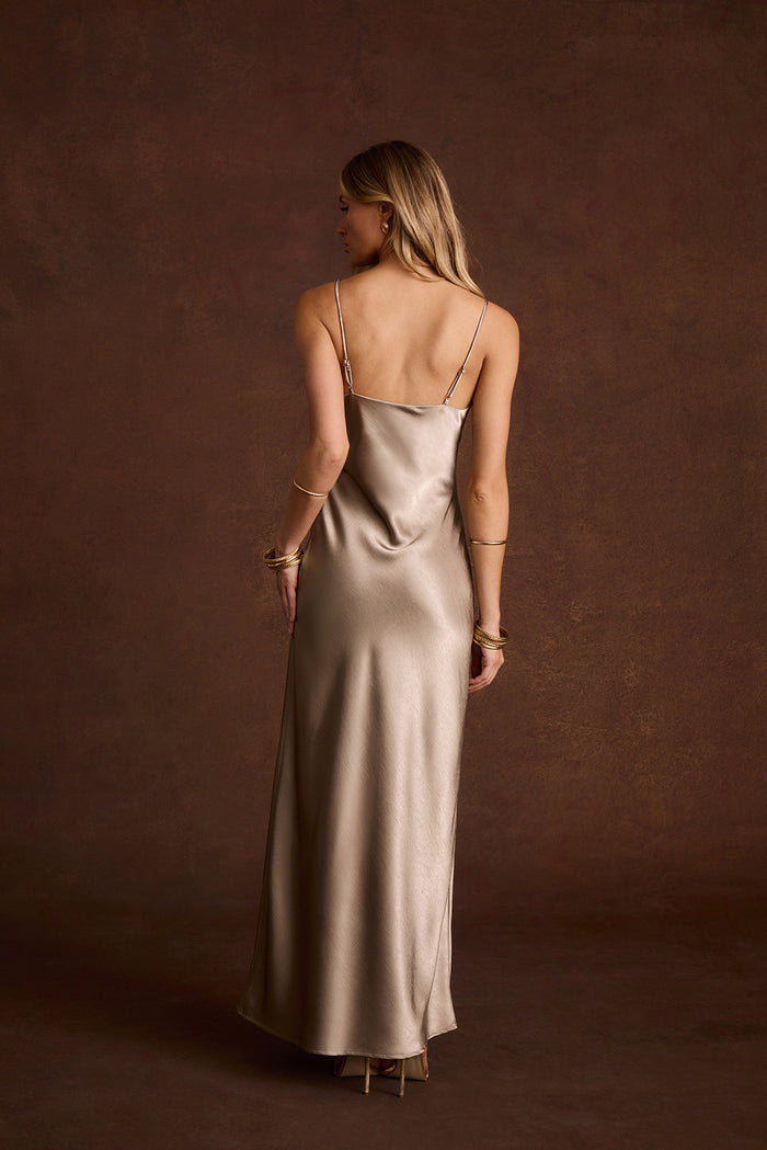 Back view of a taupe satin slip maxi dress with thin straps and a low back.