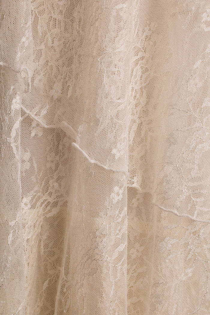 Close-up of cream floral lace fabric showing tiered layers on the Mon Amour maxi dress.