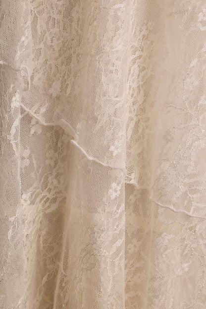 Close-up of cream floral lace fabric showing tiered layers on the Mon Amour maxi dress.