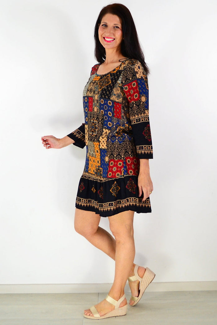 Moroccan mosaic tunic dress by Hourglass featuring colorful, intricate patterns and flowing fabric displayed on a mannequin.