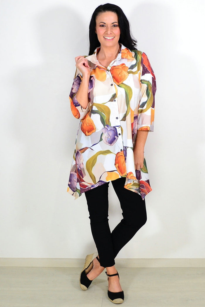 Wishstone orange artwork swirls tunic shirt with vibrant, artistic pattern, featuring a relaxed fit and flowing fabric.