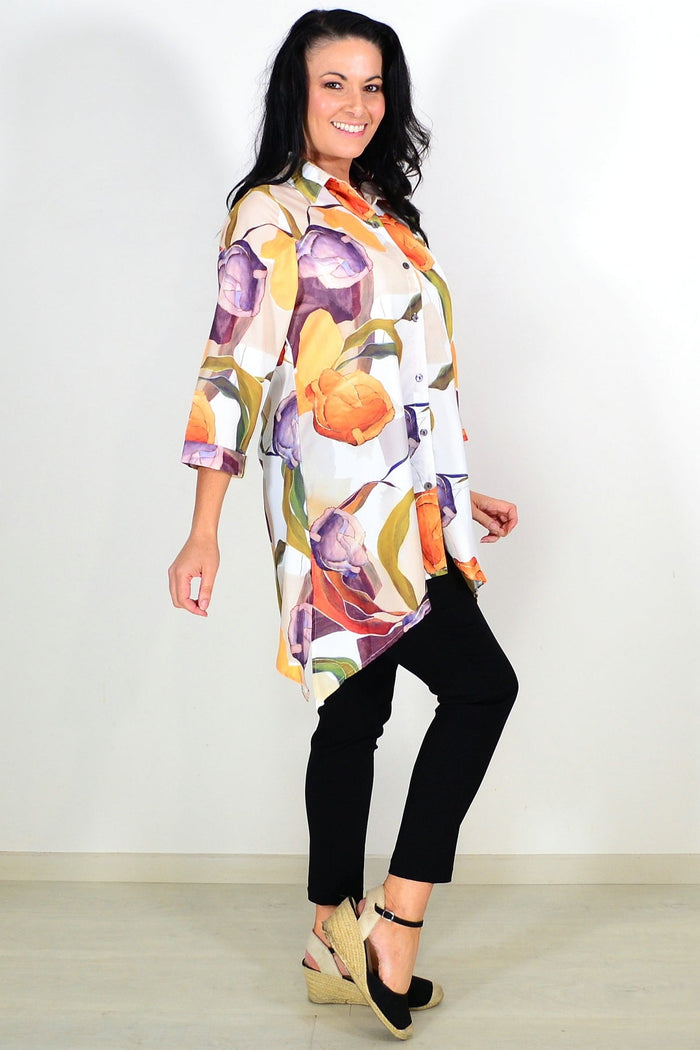 Orange artwork swirls tunic shirt by Wishstone, featuring vibrant abstract swirl designs and a relaxed fit.