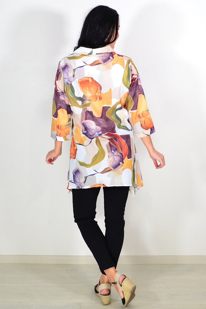Orange artwork swirls tunic shirt by Wishstone featuring vibrant swirl patterns and a comfortable fit.