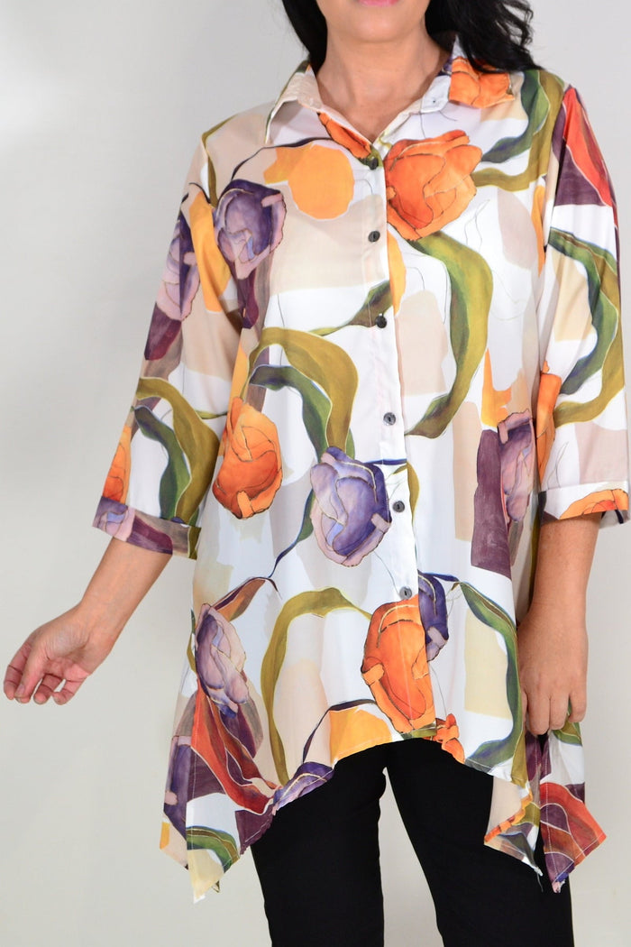 Orange artwork swirl design tunic shirt by Wishstone, featuring vibrant patterns and flowing fabric, showcased on a model.