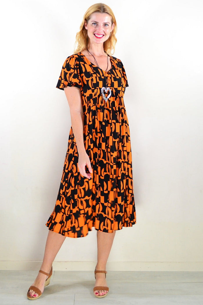 Orange and black printed tunic dress by Hourglass, featuring a stylish design and comfortable fit, shown on a model.