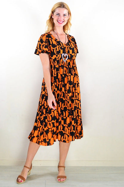 Orange and black printed tunic dress by Hourglass, featuring a stylish design and comfortable fit, shown on a model.